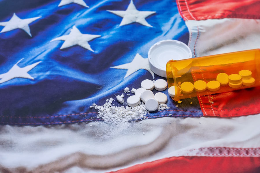 Pill bottle spilling onto US flag