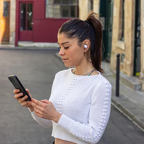 Young woman using NAOX Buds